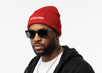 Man wearing a red beanie with 'Crown Logic' text, sunglasses, and black hoodie on a white background